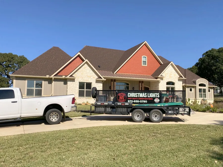 The South Custom Lighting truck and branded equipment trailer parked at a North Texas job site