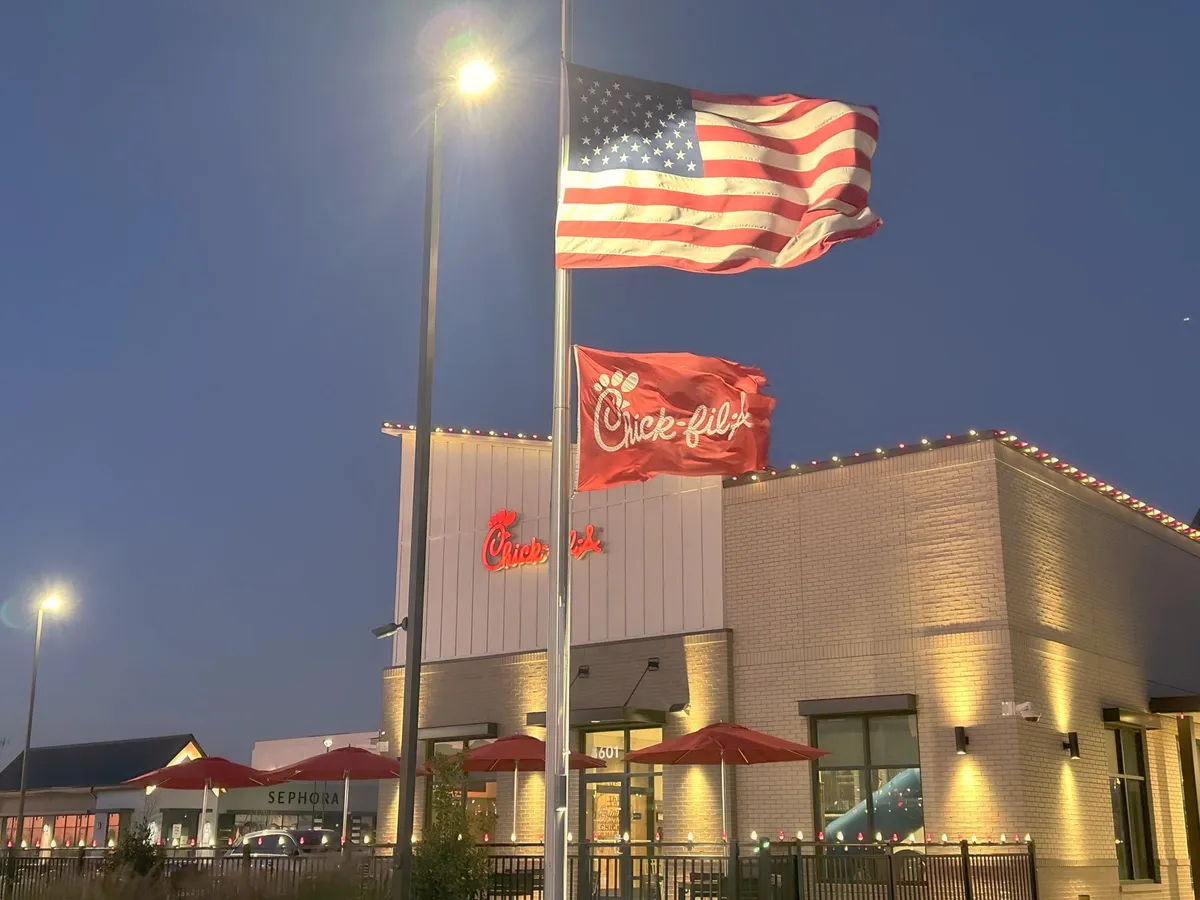 Restaurant roofline and entry at dusk, installed by South Custom Lighting in North Texas