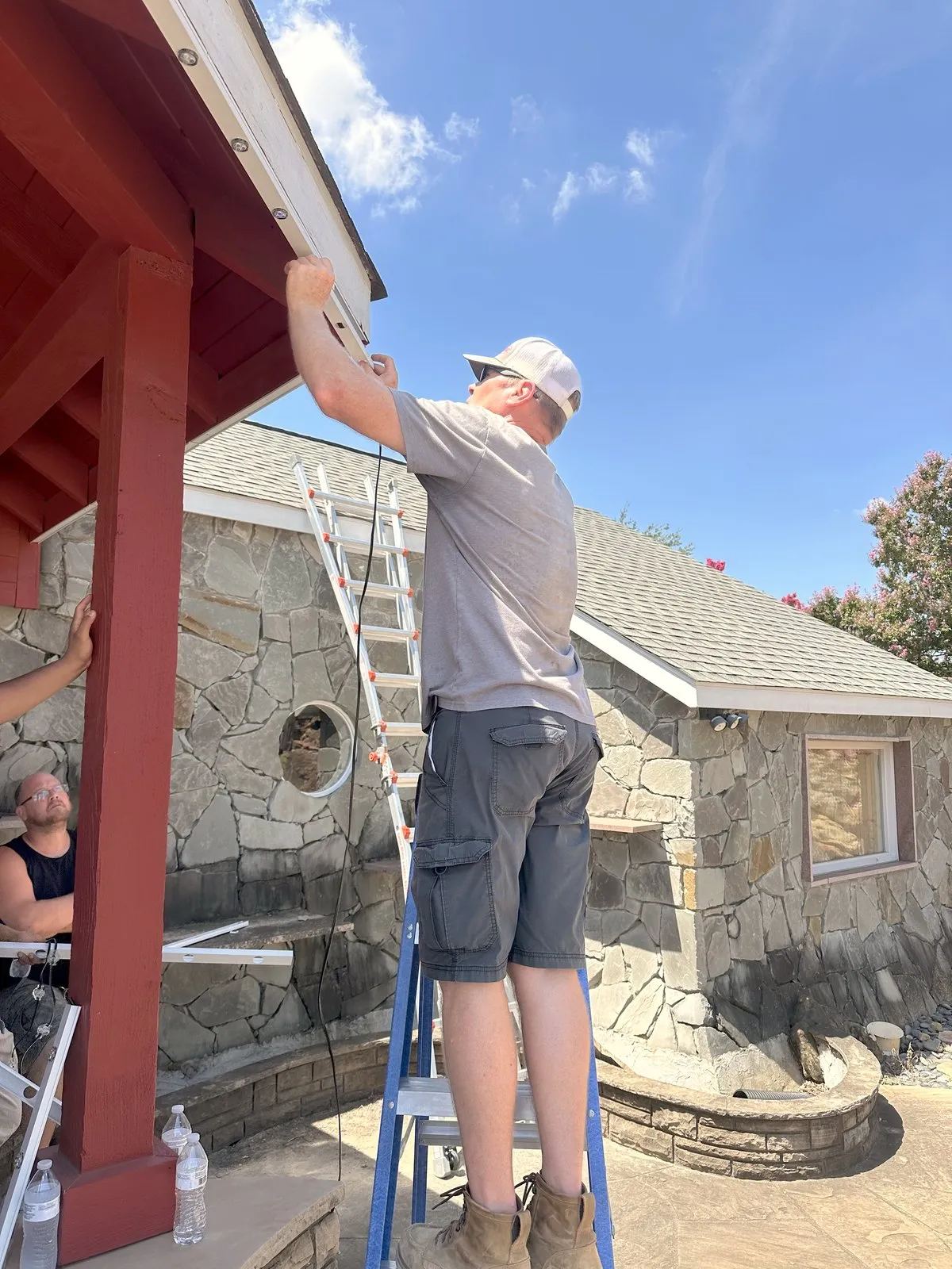 A South Custom Lighting crew working from ladders on install day in North Texas