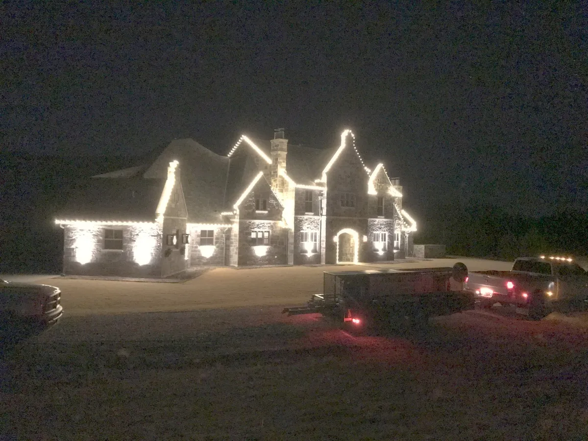 Multiple gables picked out in warm white, installed by South Custom Lighting in North Texas