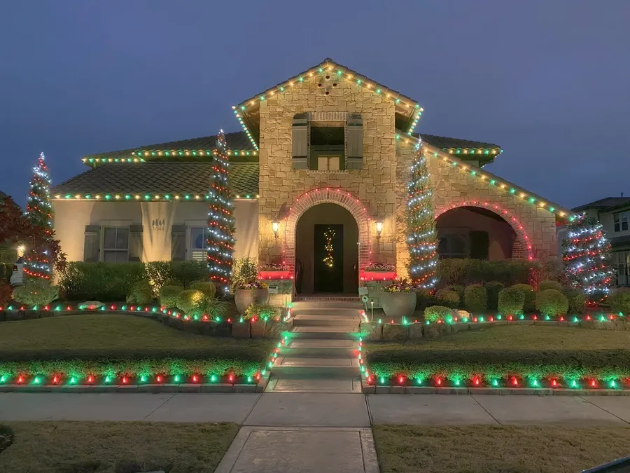 Roofline, trees, beds and walkway all lit, shot at blue hour, installed by South Custom Lighting in North Texas